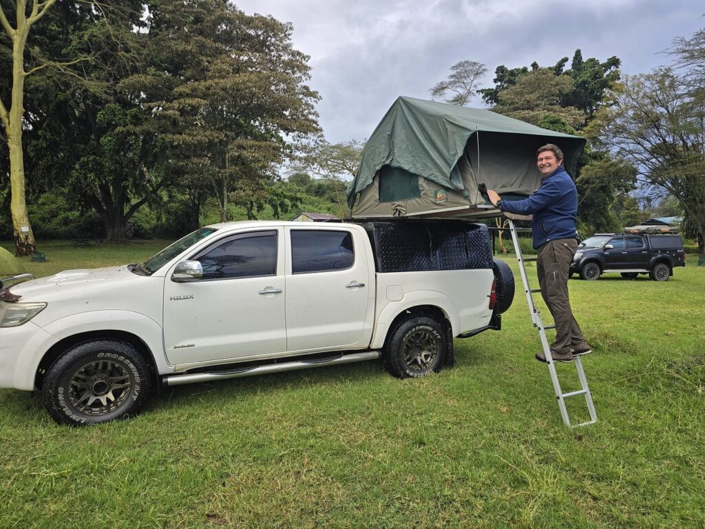 a landcruiser double cabin with a single rooftop tent